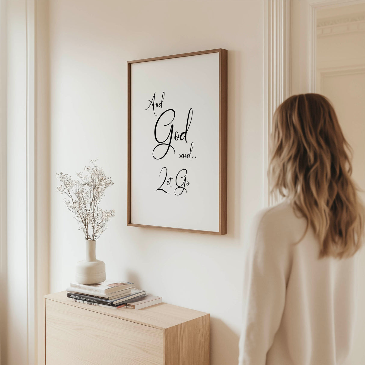 Minimalist Christian wall art print with black swirly text reading "And God said let go" on a white background.