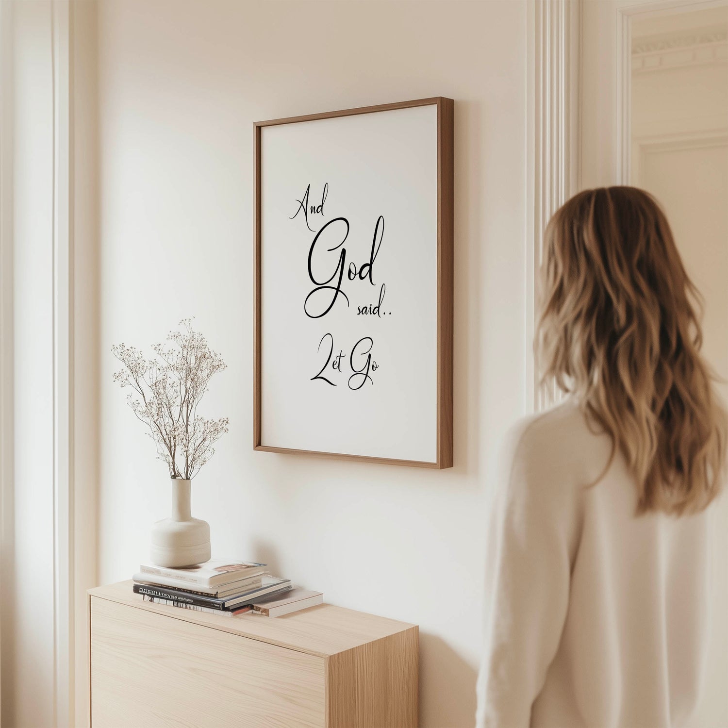 Minimalist Christian wall art print with black swirly text reading "And God said let go" on a white background.