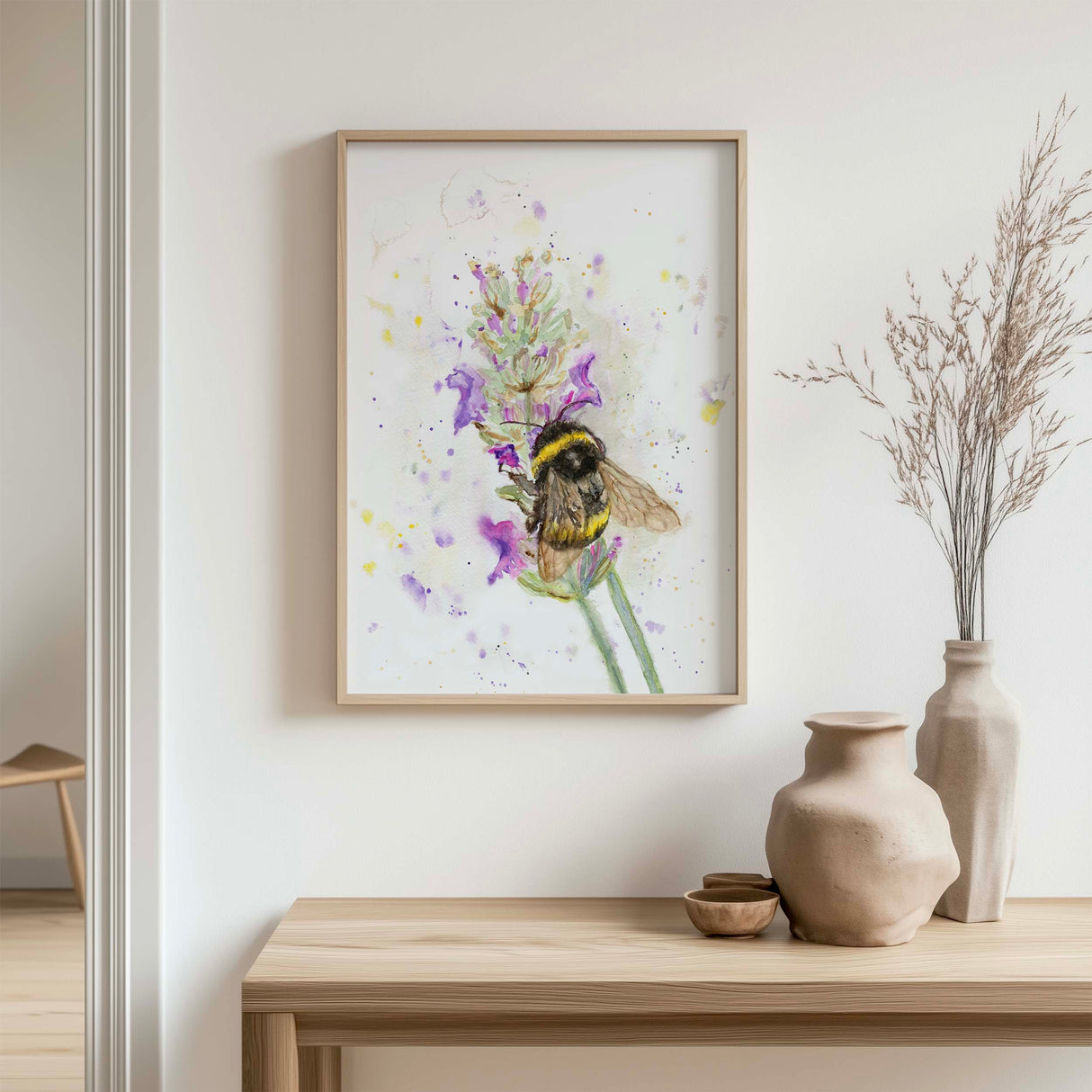 Watercolour painting of a bumblebee sitting on a lavender flower with soft purple and yellow tones.