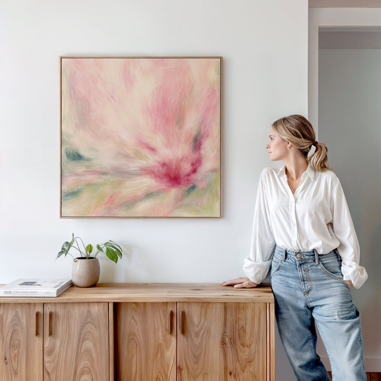 Abstract square painting with peach, pink, and green hues resembling a blooming flower.