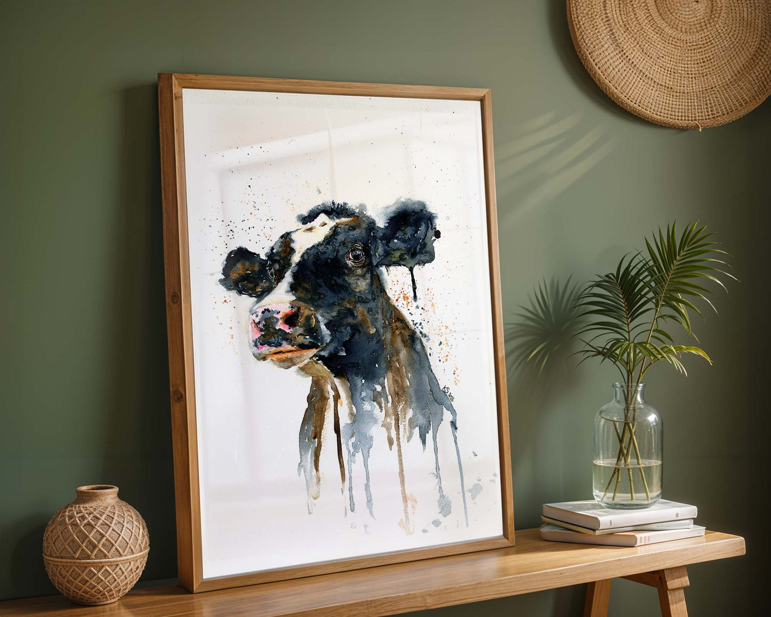 Watercolour painting of a cow's face, featuring expressive eyes and soft brushstrokes in warm browns and gentle greys.