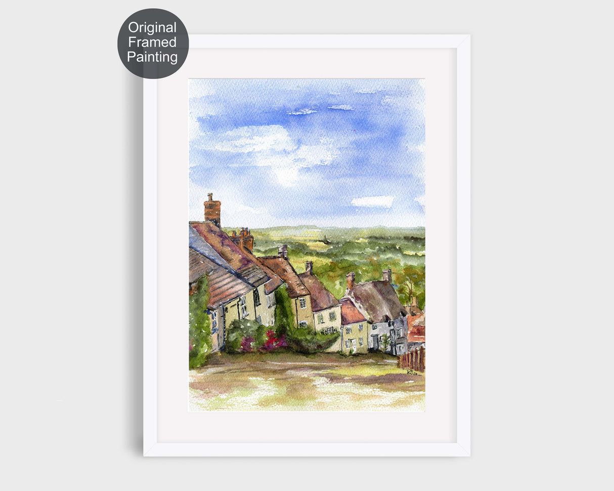 Watercolour painting of Gold Hill, Shaftesbury, featuring historic cottages and countryside views.