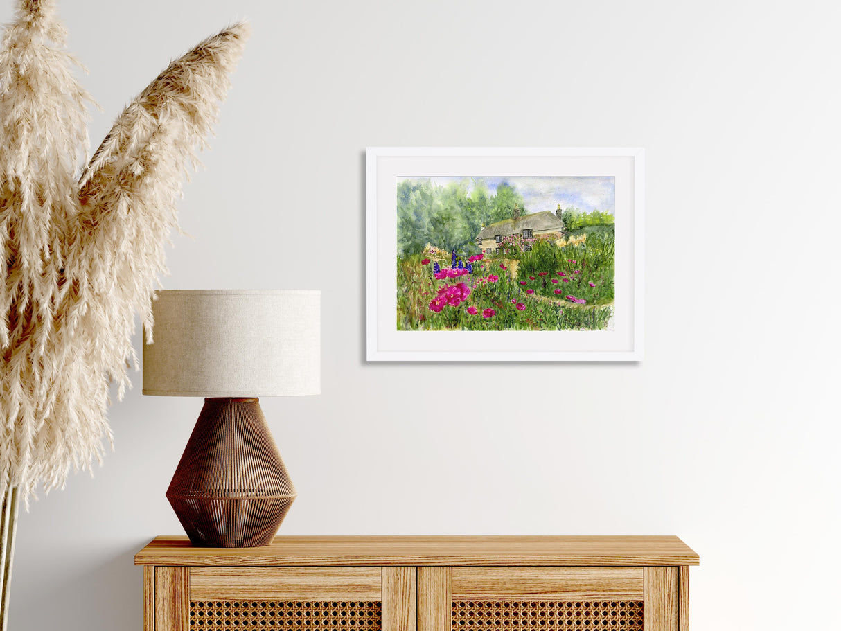 Loose watercolour landscape showing Hardy’s Cottage surrounded by vibrant wildflowers in full bloom under a soft, summer sky.