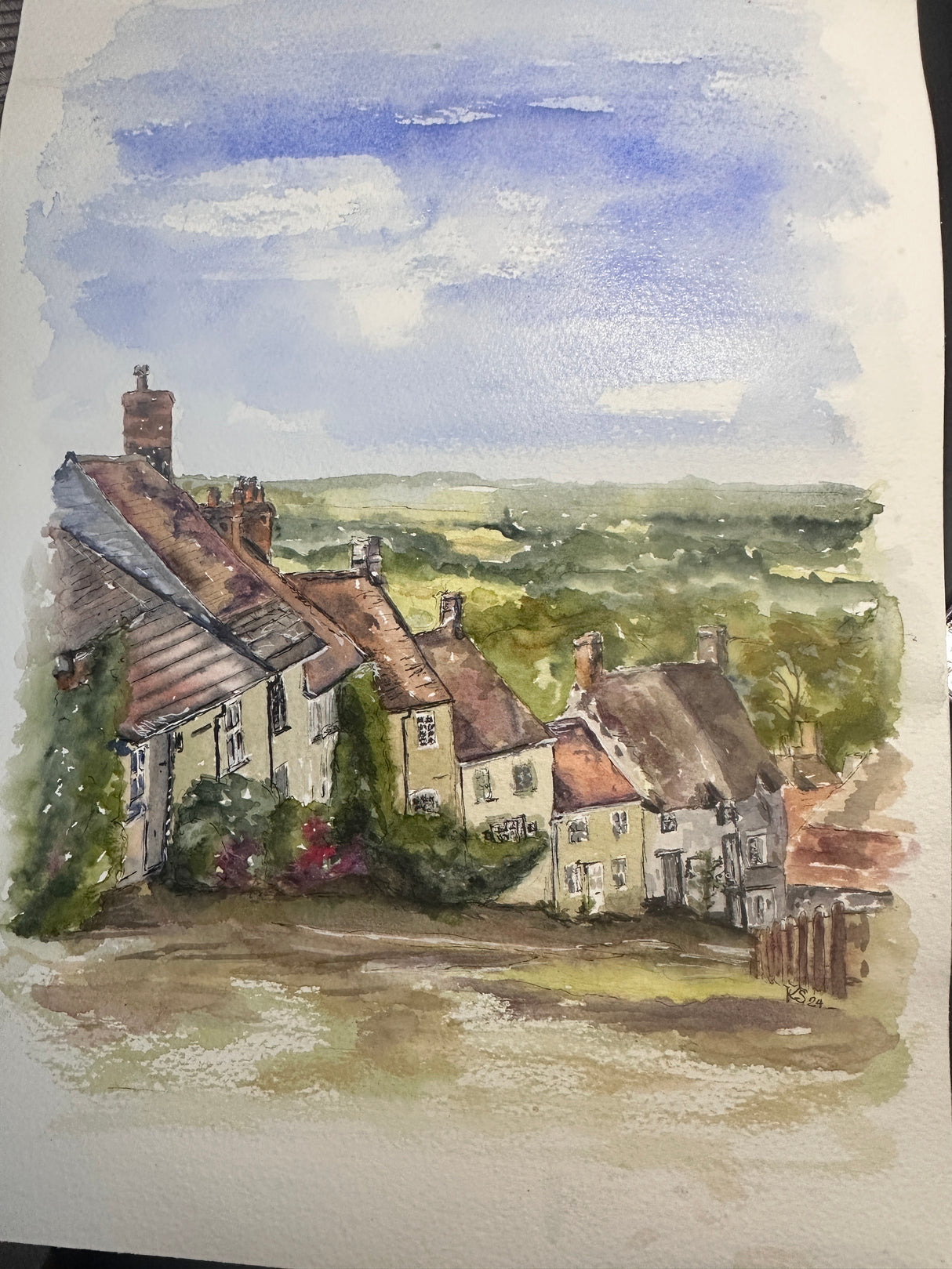 Hand-painted artwork of Gold Hill in Dorset, with cobbled streets and scenic greenery.