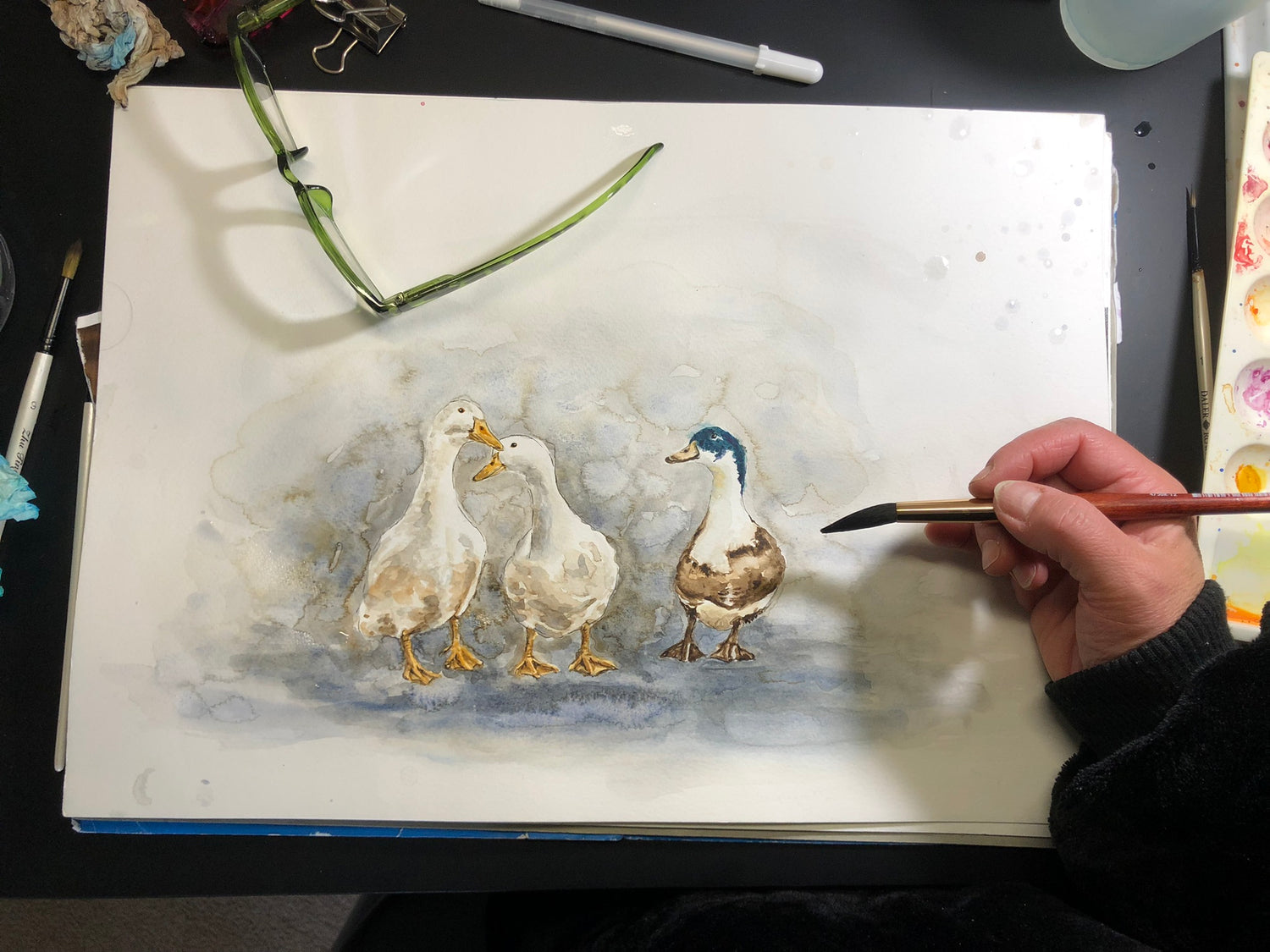 Charming duck trio painted in watercolours with delicate brushstrokes and natural hues.