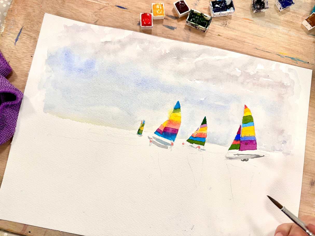 Sailing boats with bright sails in a peaceful harbour scene