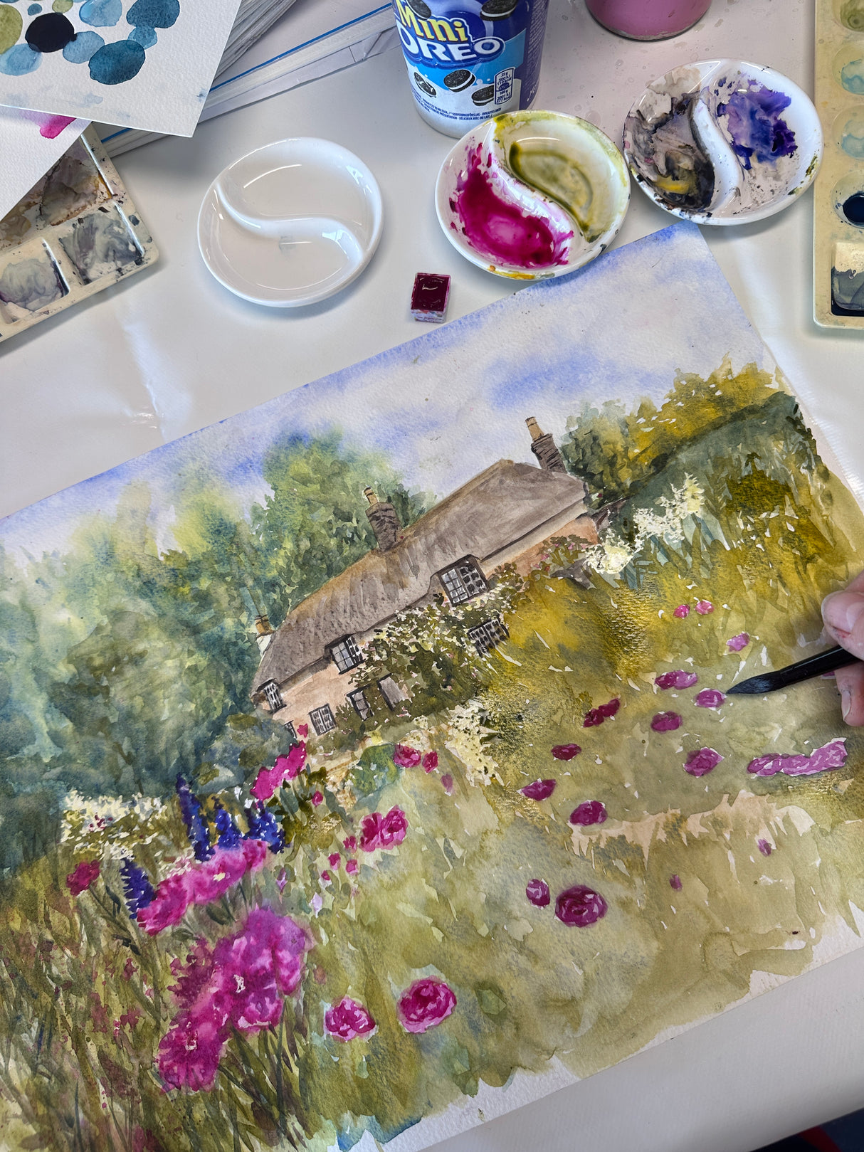 Watercolour painting of Dorset countryside near Hardy’s Cottage, filled with blooming flowers and lush greenery in a dreamy style.