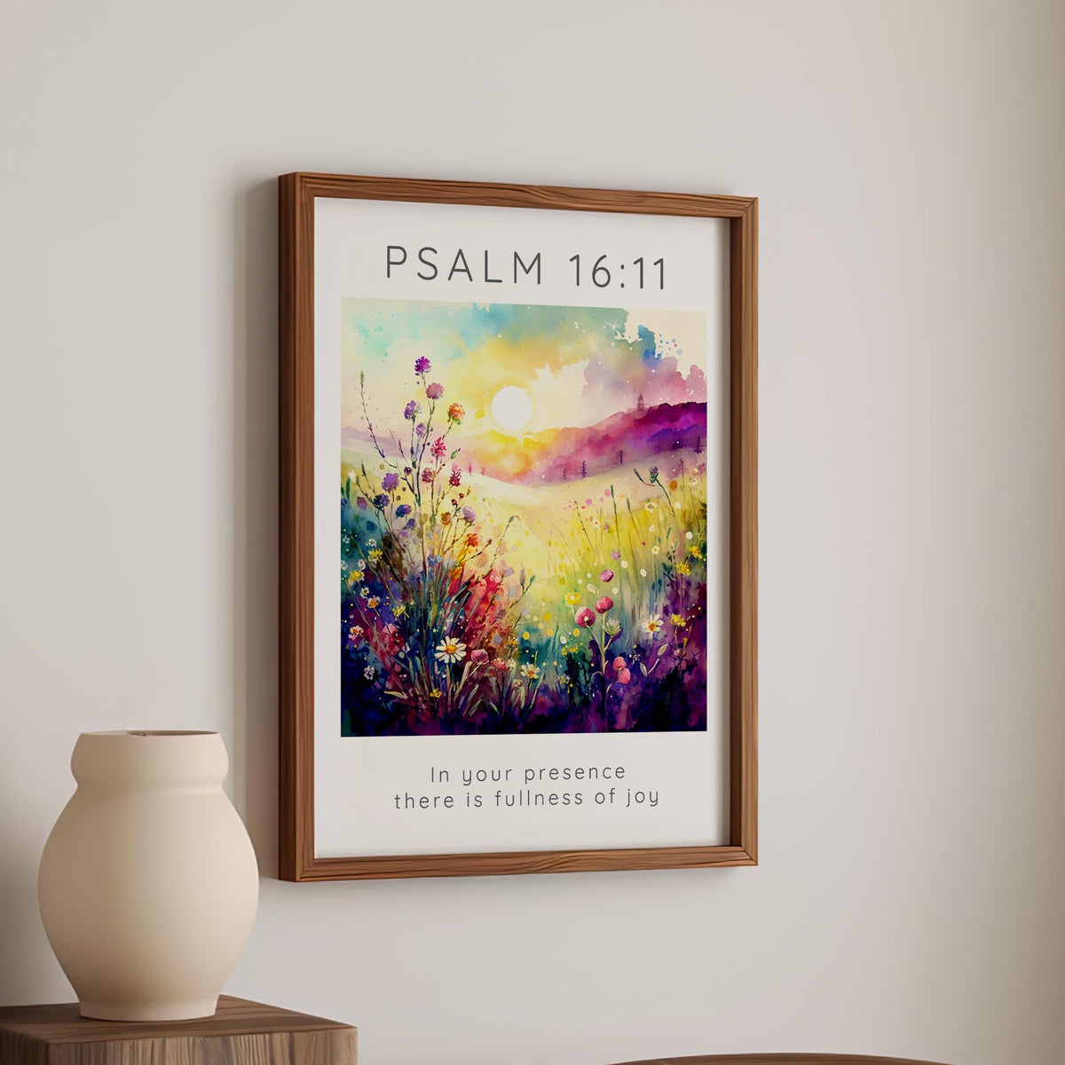 A peaceful meadow-themed Bible verse print with lush greenery and wildflowers. The scripture "In your presence there is fullness of joy" is elegantly placed under the artwork, while the Bible reference stands out in bold capital letters above.