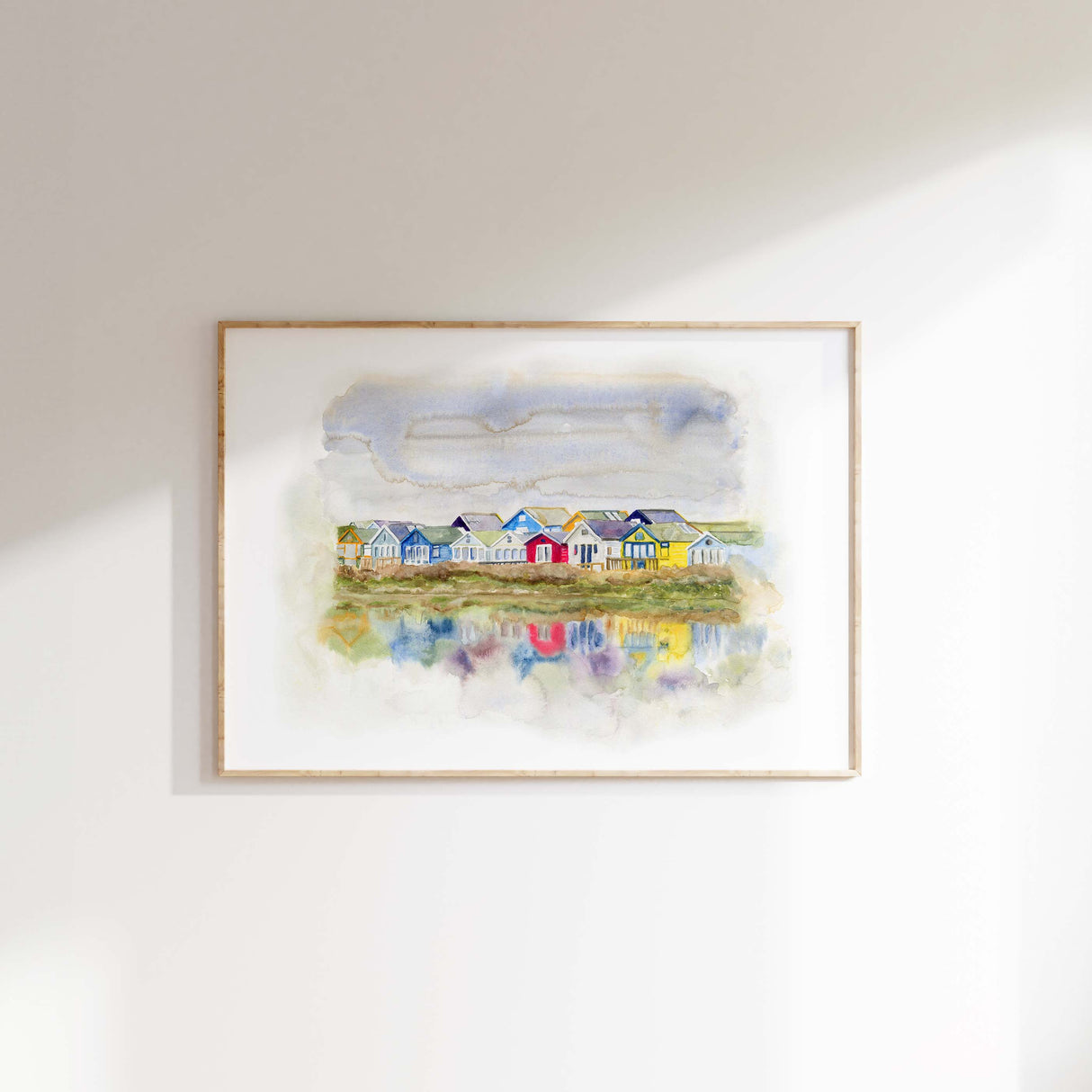 Loose watercolour art print of Dorset beach huts in red, green, yellow and blue