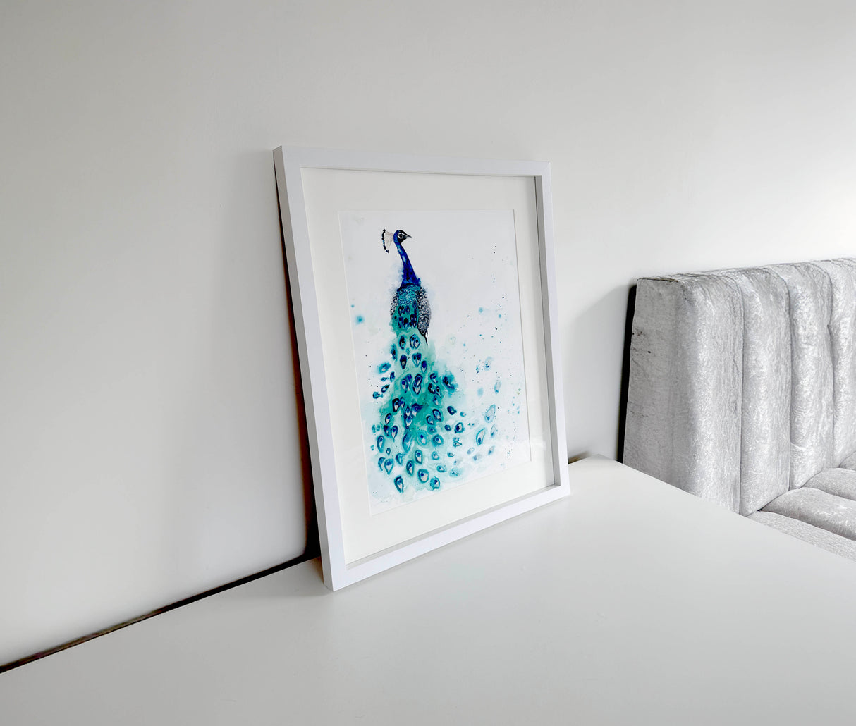 Detailed peacock watercolor piece showing vibrant shades of blue and green, with flowing feather patterns and lifelike movement.