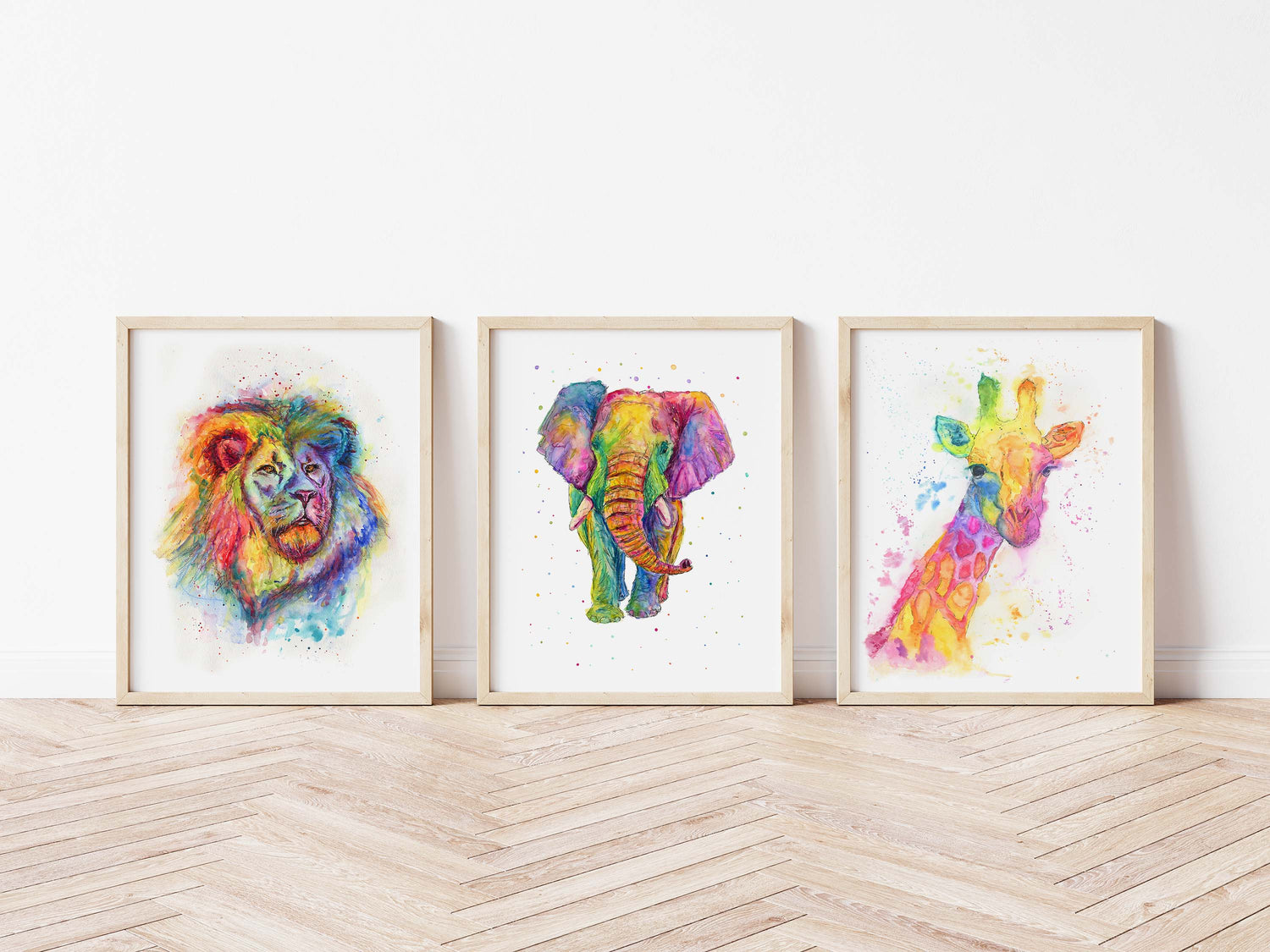 A vibrant rainbow watercolour print set featuring an elephant, giraffe, and lion.