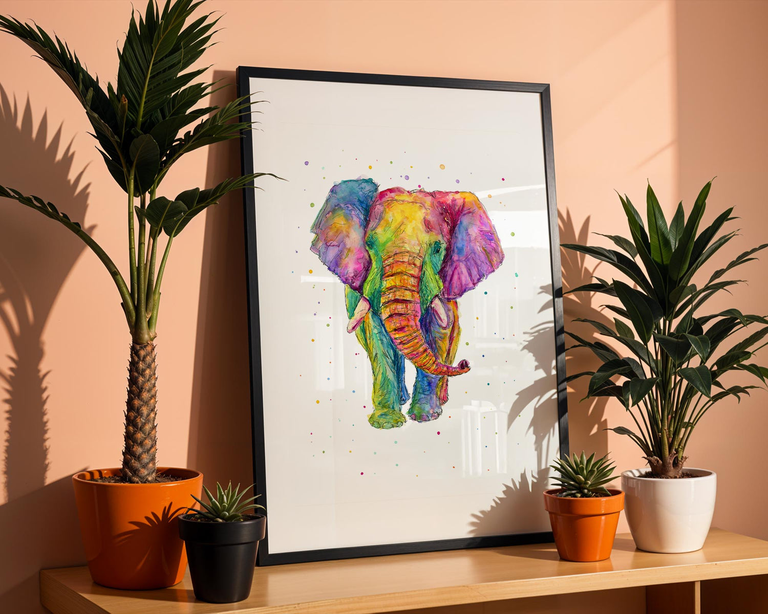 Ink and watercolour elephant art in rainbow tones with artistic paint splatter. Vibrant elephant print with rainbow colours and a fun, spattered watercolour background.