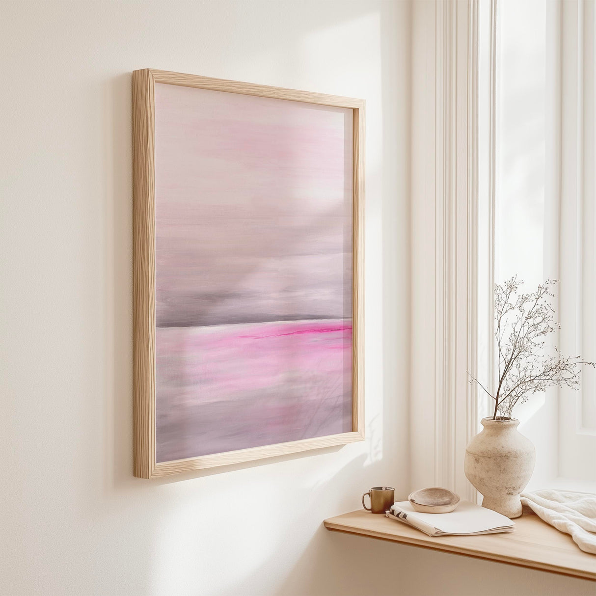 A soft pink and grey ocean wave print capturing the quiet calm of still water in delicate watercolour tones.