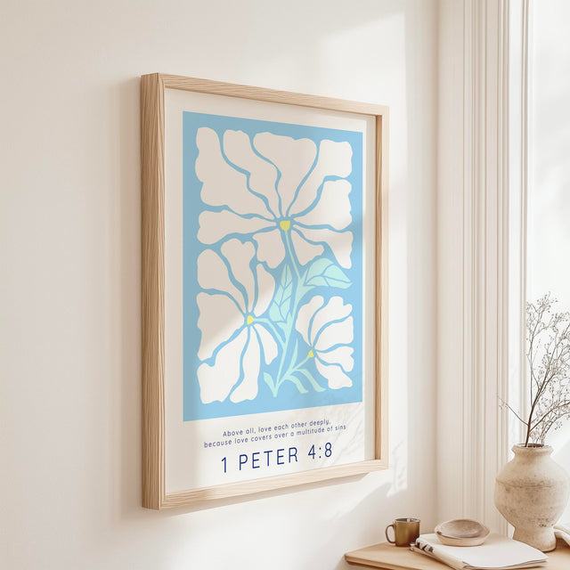 Bible verse print with 1 Peter 4:8 and floral artwork on a light blue background, encouraging deep love and grace.