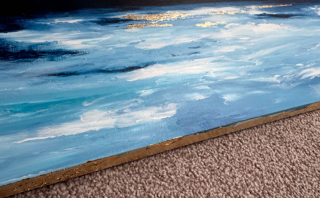 Serene ocean horizon painting with gold highlights, Contemporary artwork featuring blue, white, and gold