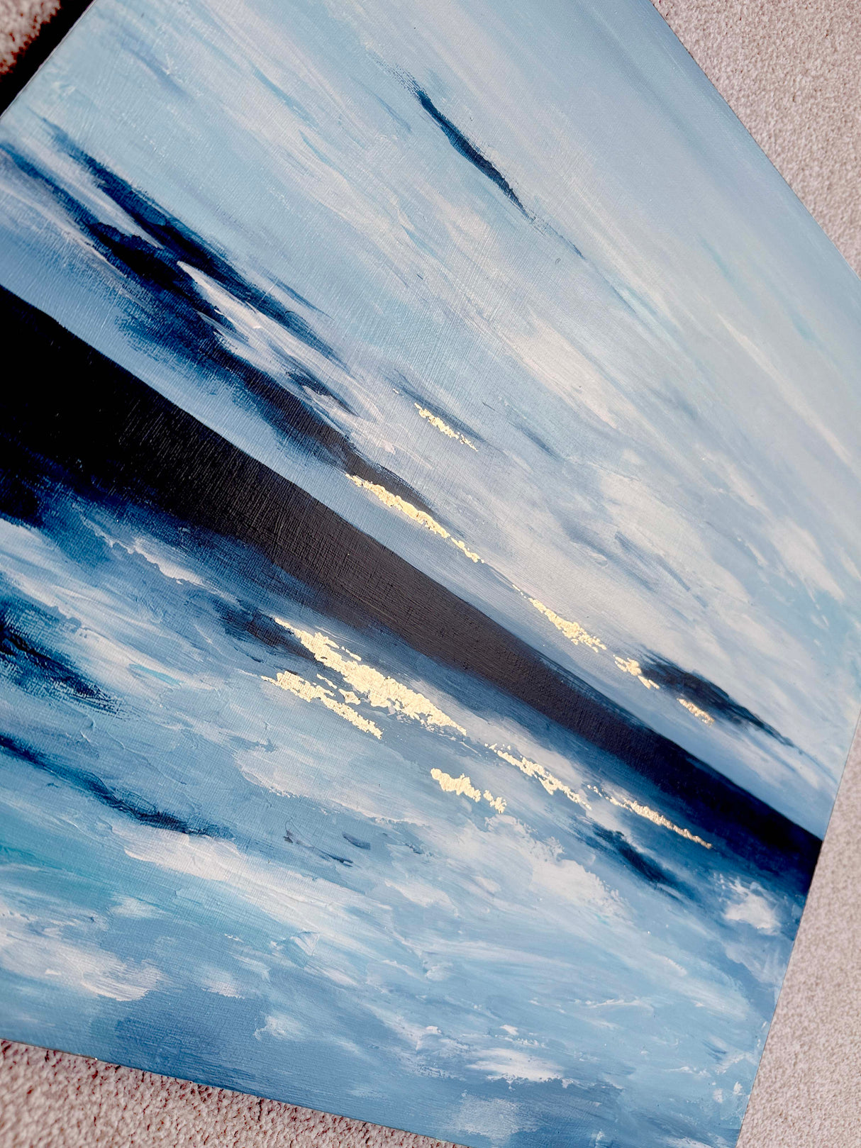 Serene ocean horizon painting with gold highlights, Contemporary artwork featuring blue, white, and gold