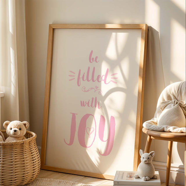 Christian nursery wall art print with pink ‘Be Filled With Joy’ text and Romans 15:13 verse on a white background.