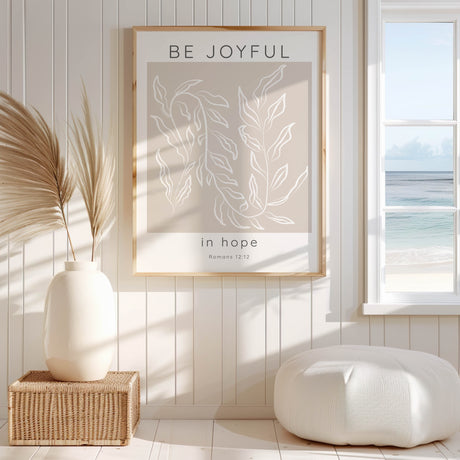 Neutral beige and white Christian print with "Be joyful in hope" Bible verse from Romans 12:12 and leafy motif.