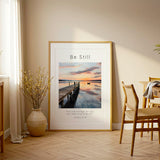 Exodus 14:14 - Be Still scripture print with golden sunset reflecting on calm lake water and distant boat.