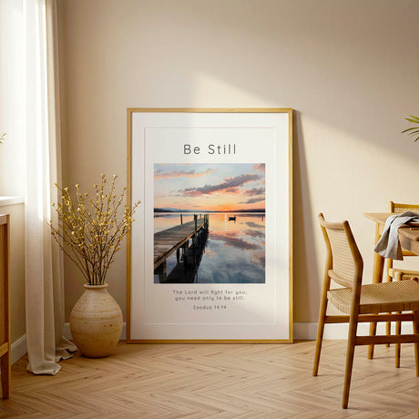Exodus 14:14 - Be Still scripture print with golden sunset reflecting on calm lake water and distant boat.