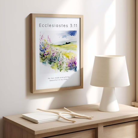 Christian wall art featuring the verse “He has made everything beautiful in its time” set against a vibrant floral landscape.