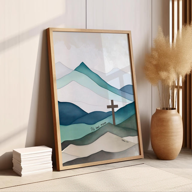 Christian wall art featuring a cross on a mountain landscape with the verse “He Has Risen” from Matthew 28:6, symbolising the resurrection.