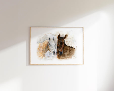 Two horses, one white and one brown, touching heads in a symbol of closeness.