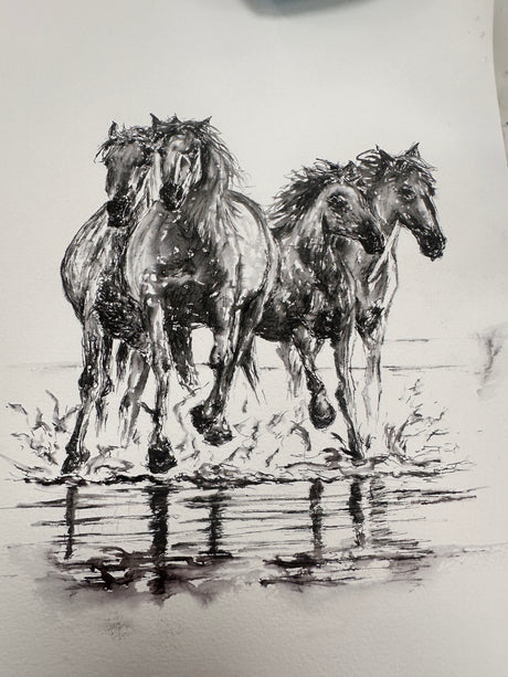 Detailed pen and ink artwork of horses running on a beach, created on watercolor paper. Captures energy and motion. This piece has sold.