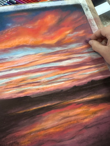 Vibrant seascape painting with a glowing sunset over the British coastline, created using pastels.