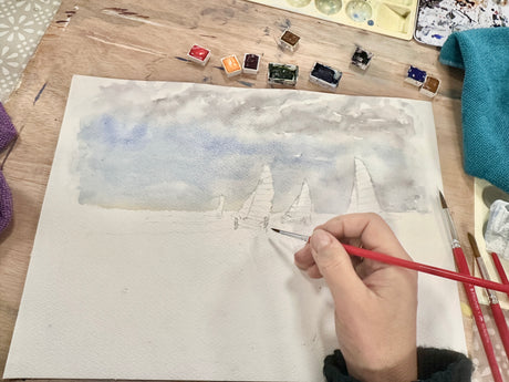 Watercolour seascape with rainbow sails against a soft blue sea