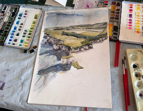 Watercolour artwork showing the English coast from above