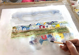 Colourful framed painting of Mudeford beach huts by Dorset artist, with whimsical style and abstract reflections.