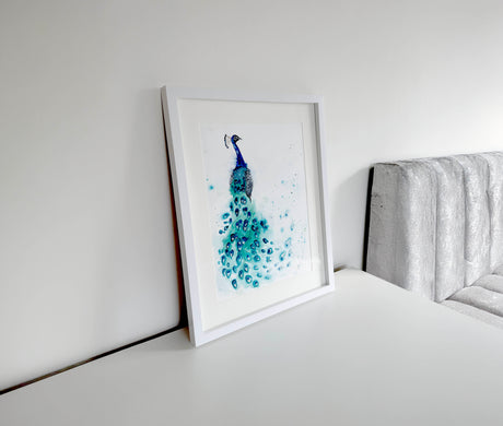 Detailed peacock watercolor piece showing vibrant shades of blue and green, with flowing feather patterns and lifelike movement.