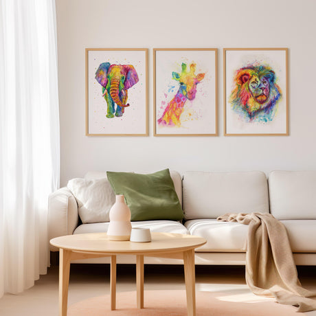 Bright and cheerful rainbow animal art prints, featuring a giraffe, lion, and elephant.