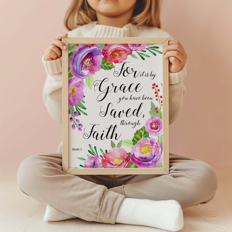 Pink floral Bible verse print featuring Ephesians 2:8 in elegant script. Christian wall art with delicate pink flowers and the verse “For it is by grace you have been saved, through faith.”