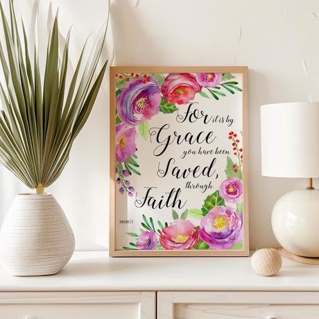 floral print highlighting the comforting message from Ephesians 2:8. Stylish pink Bible verse artwork with blossoms surrounding a message of faith and grace.