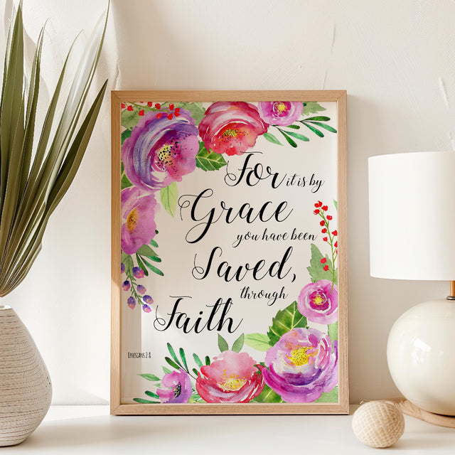 floral print highlighting the comforting message from Ephesians 2:8. Stylish pink Bible verse artwork with blossoms surrounding a message of faith and grace.