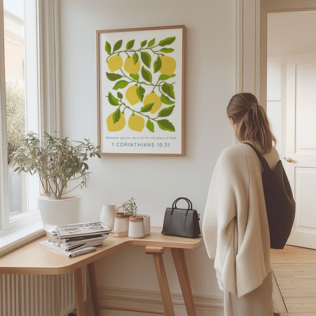 Christian print saying Whatever You Do Do It All For The Glory Of God, surrounded by yellow lemons and green foliage.